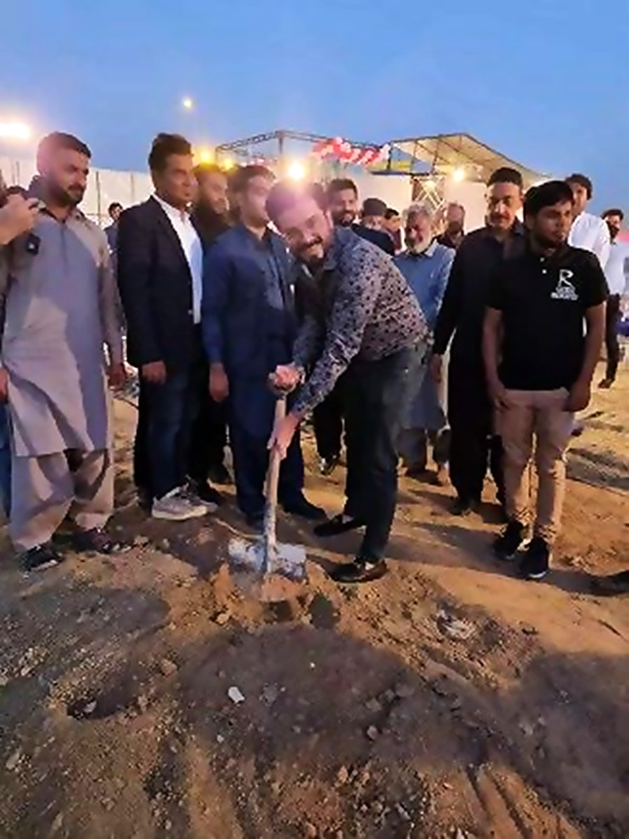 Breaking ground with a shovel at an Anum Builders ceremony
