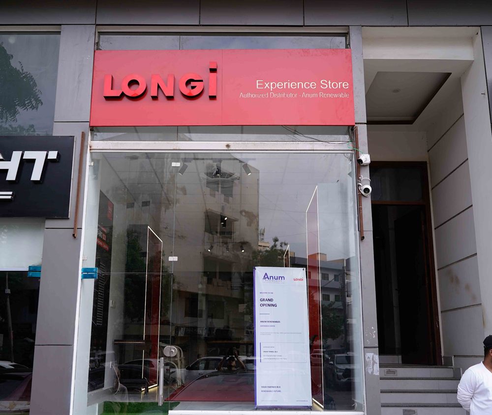 Red LONGi Experience Store sign reading Authorized Distributor, Anum Renewable, above a glass shopfront