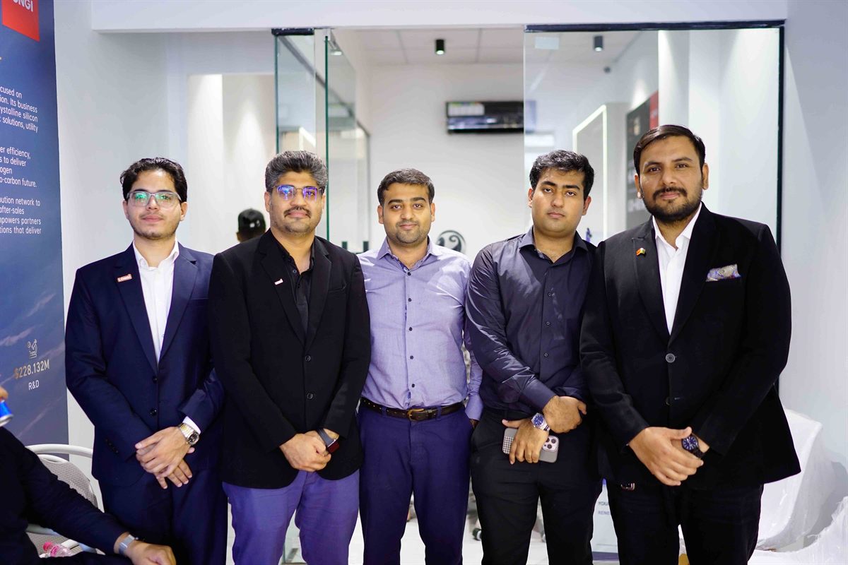 Five members of the management team in suits at the LONGi Experience Store