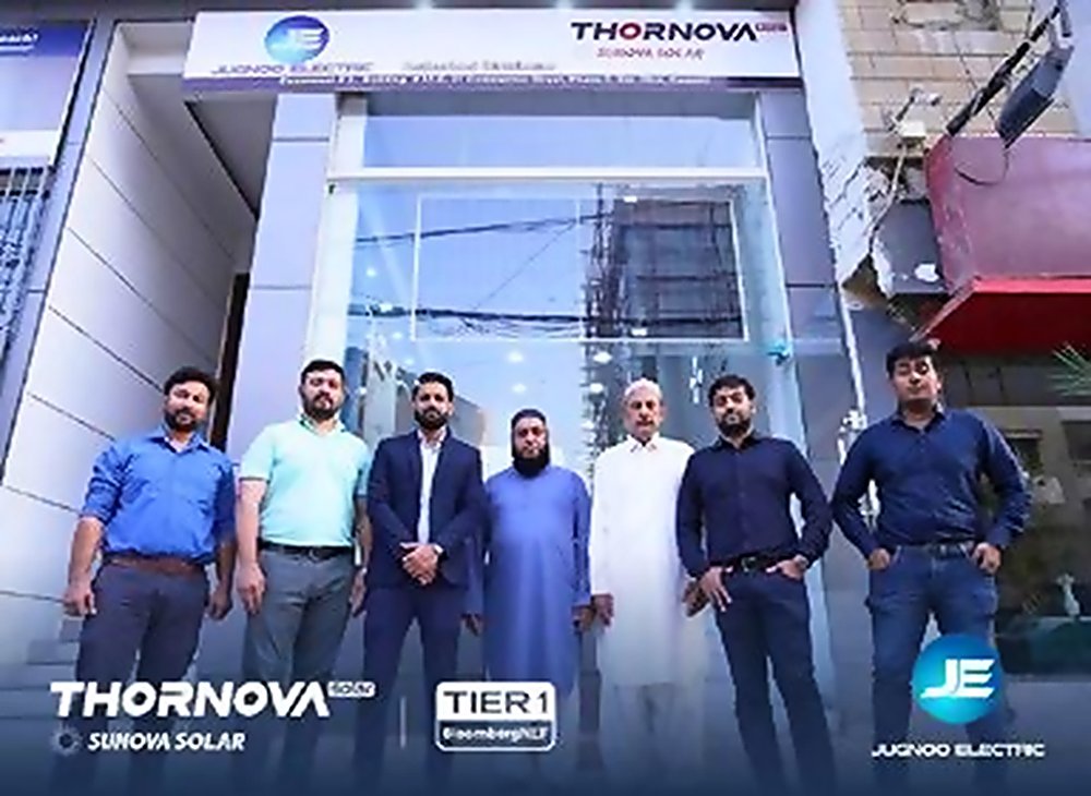 Seven members of the Jugnoo Electric team standing outside a Jugnoo Electric and Thornova shopfront